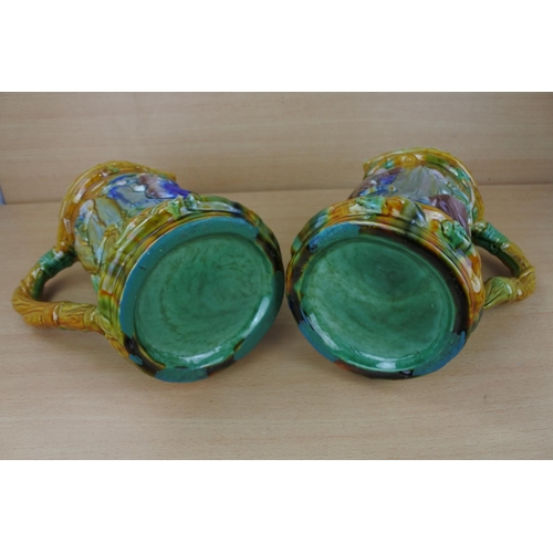 833 - A stunning pair of glazed pottery jugs.