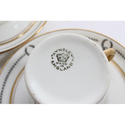 929 - A set of six Aynsley coffee cups and saucers.