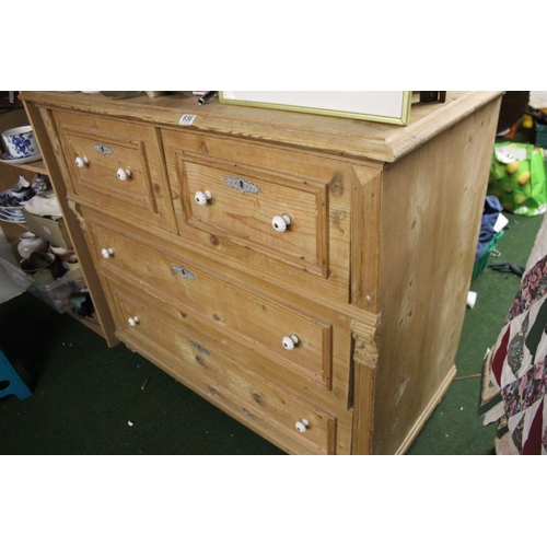 936 - A stunning antique pine chest of four drawers with porcelain drawer pulls.