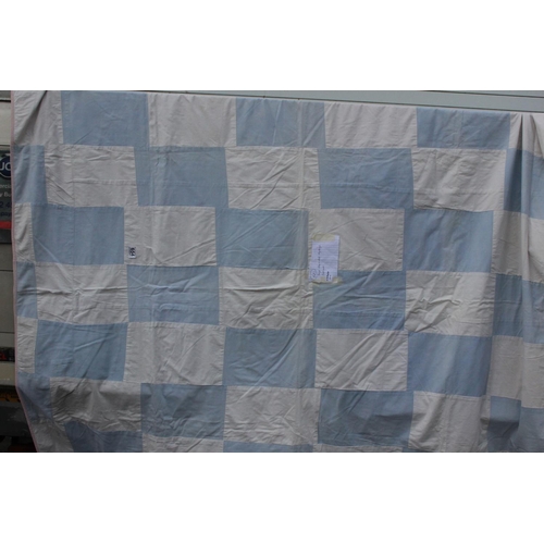 940 - A handmade large blue and white rectangular patchwork quilt. Measuring 68x74inches.