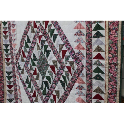 941 - A large patchwork style quilt.