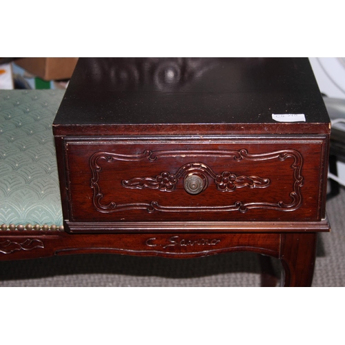 944 - An upholstered telephone table with drawer.