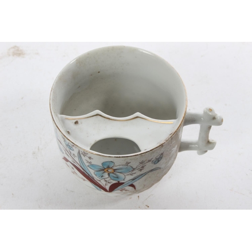 958 - A decorative antique Gents Moustache cup.