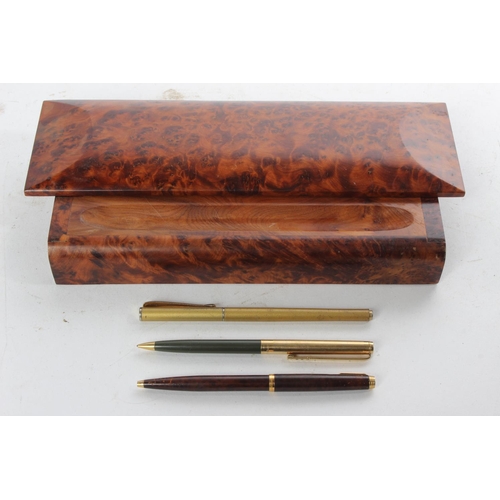 994 - A decorative walnut pen tray/ tidy with 3 pens.