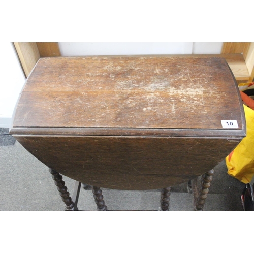 10 - An antique drop leaf table with barley twist legs.