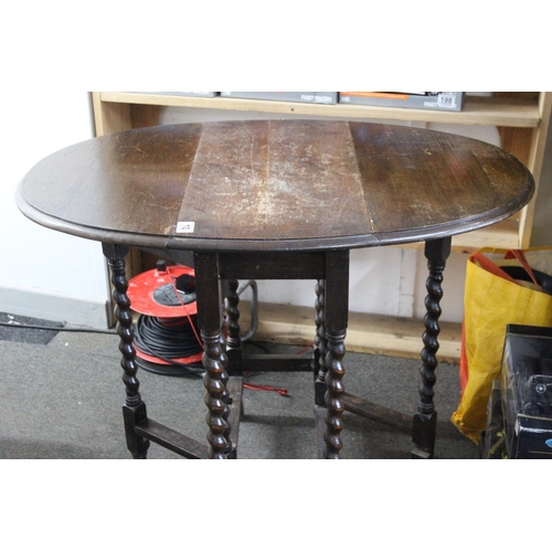 10 - An antique drop leaf table with barley twist legs.