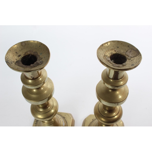 33 - A pair of large antique brass candlesticks.