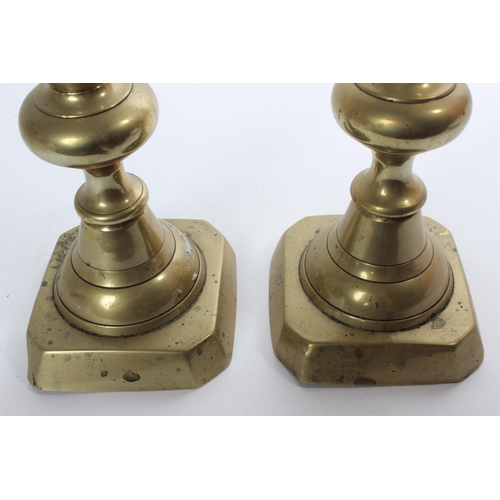 33 - A pair of large antique brass candlesticks.