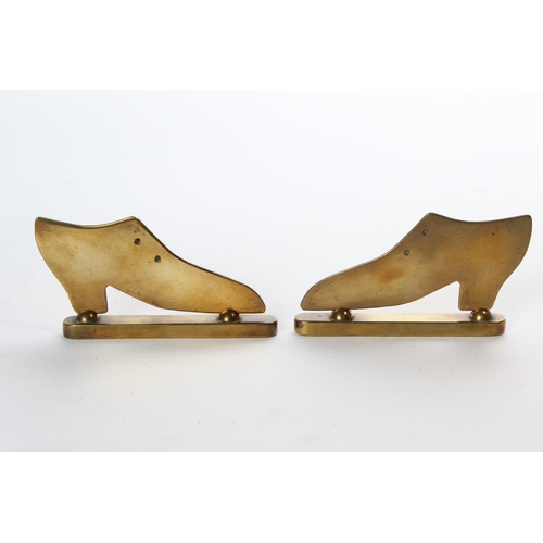 61 - A pair of vintage brass shoe ornaments on stands.