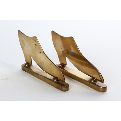 61 - A pair of vintage brass shoe ornaments on stands.