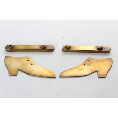 61 - A pair of vintage brass shoe ornaments on stands.