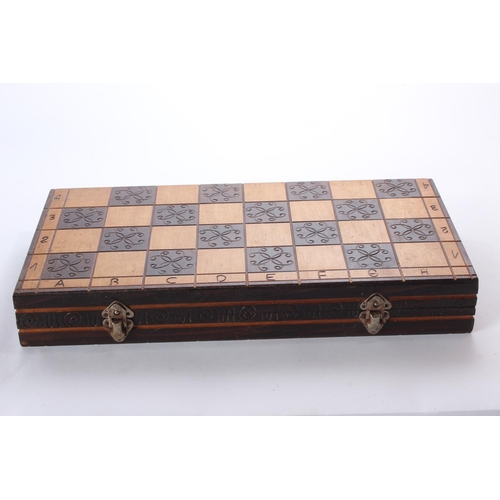 137 - A wooden cased chess board and pieces.
