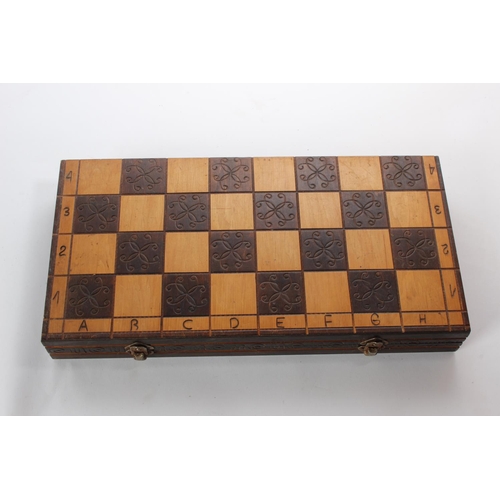 137 - A wooden cased chess board and pieces.