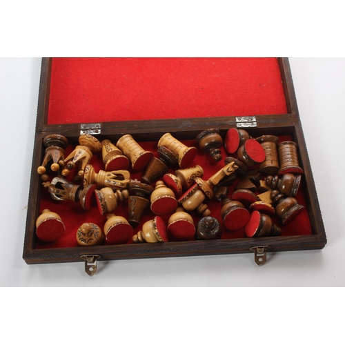 137 - A wooden cased chess board and pieces.