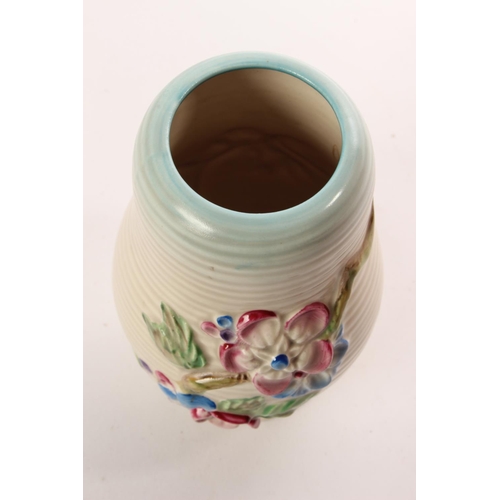 164 - A stunning Clarice Cliff Newport Pottery vase decorated with flowers.
