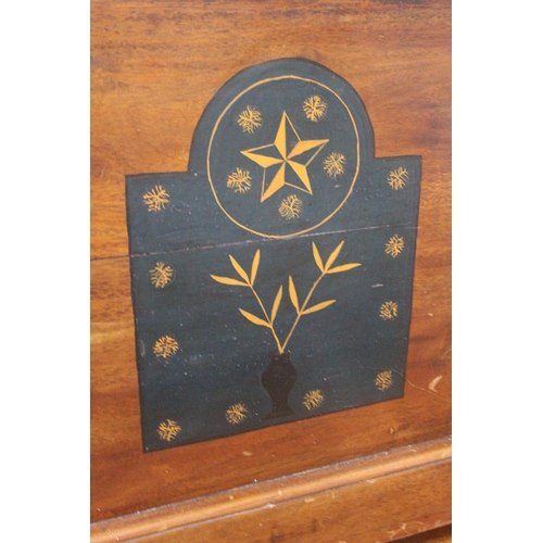 218 - A wooden blanket chest with decorative detail.