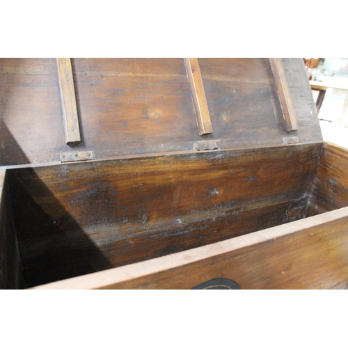 218 - A wooden blanket chest with decorative detail.