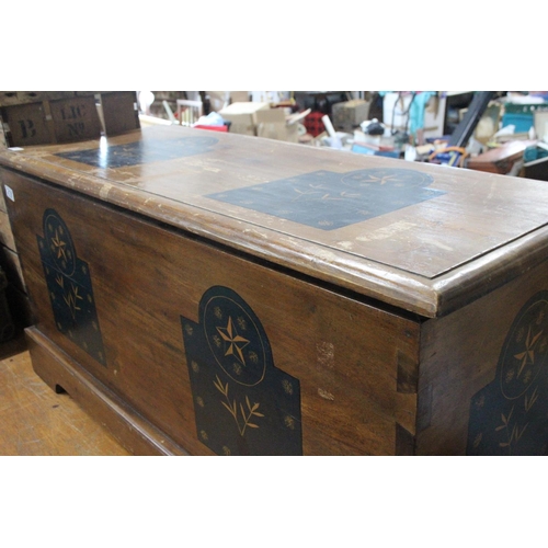 218 - A wooden blanket chest with decorative detail.