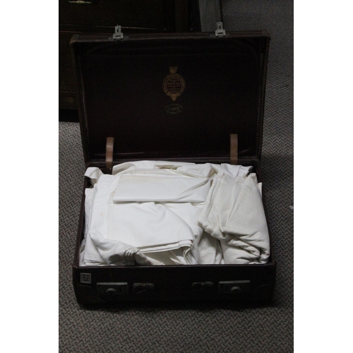 229 - A vintage leather suitcase and contents.