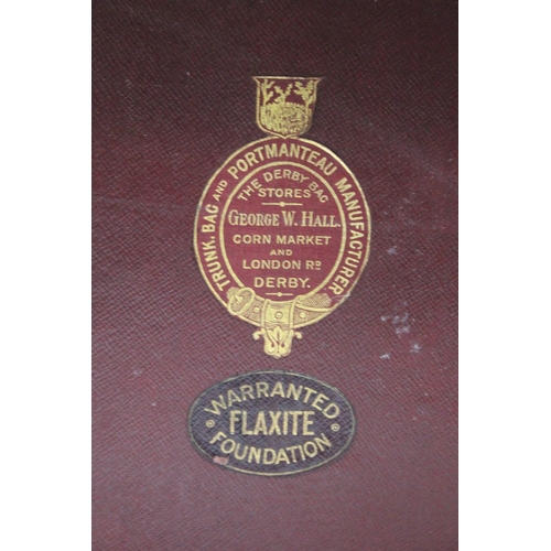 229 - A vintage leather suitcase and contents.