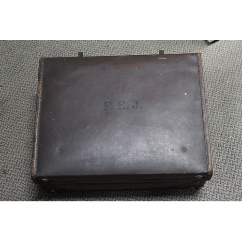 229 - A vintage leather suitcase and contents.