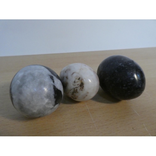 103 - Three polished marble eggs.