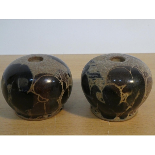 107 - A pair of studio pottery candlesticks.