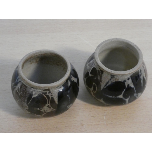 107 - A pair of studio pottery candlesticks.