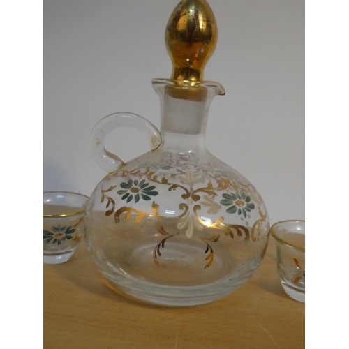 109 - A vintage hand painted decanter and six shot glass set.