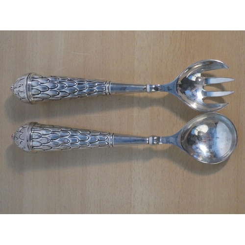 116 - A pair of metal salad servers.