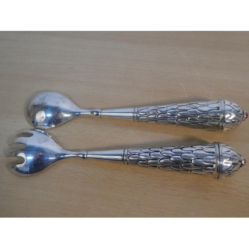 116 - A pair of metal salad servers.