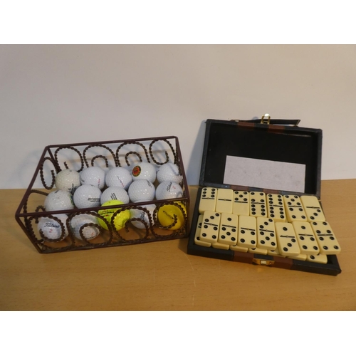 121 - A metal box of assorted golf balls and a cased set of dominoes