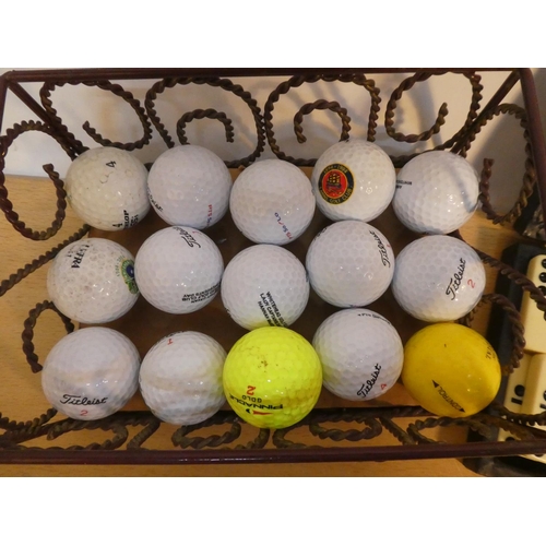 121 - A metal box of assorted golf balls and a cased set of dominoes