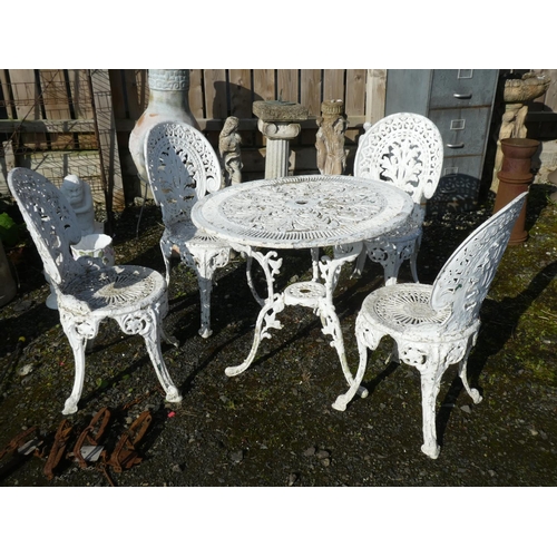 63 - A cast metal garden table and 4 matching chairs.