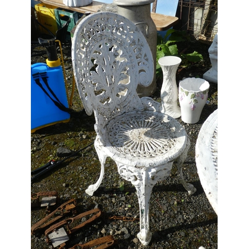 63 - A cast metal garden table and 4 matching chairs.