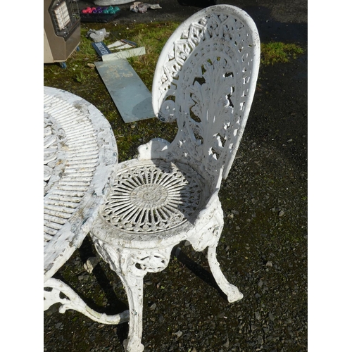 63 - A cast metal garden table and 4 matching chairs.