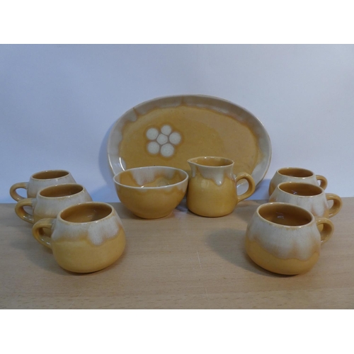 79 - A set of six Portrush Pottery coffee cups, milk jug and sugar bowl and matching platter.