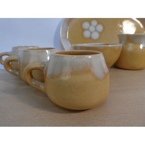 79 - A set of six Portrush Pottery coffee cups, milk jug and sugar bowl and matching platter.