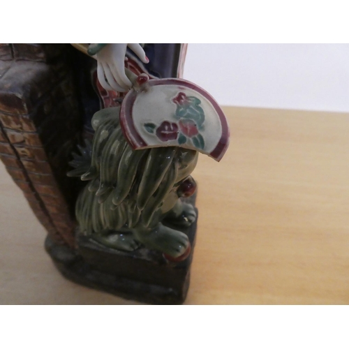 83 - An Oriental ceramic figure with foo dog, signed to base (a/f).