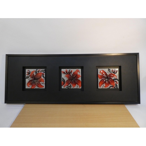 91 - A framed decorative wall panel, comprising three decorative glazed ceramics