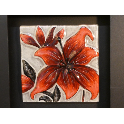 91 - A framed decorative wall panel, comprising three decorative glazed ceramics