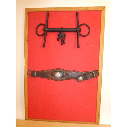 641 - An antique wrought iron horse bit and a leather strap.