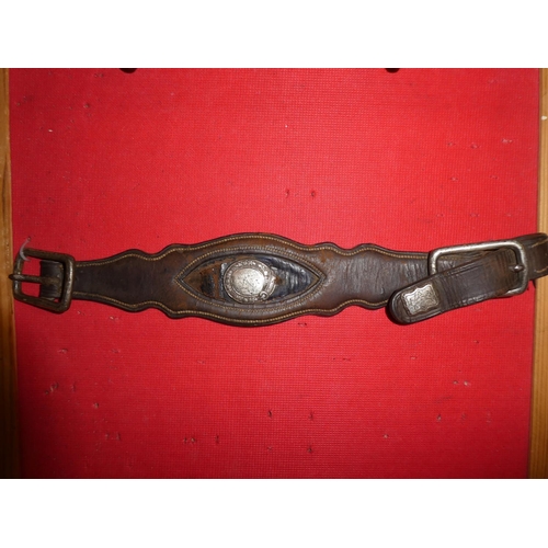 641 - An antique wrought iron horse bit and a leather strap.