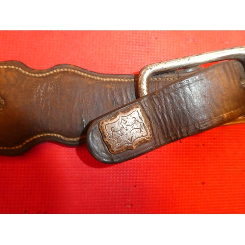 641 - An antique wrought iron horse bit and a leather strap.