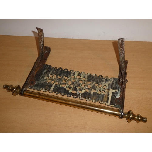 671 - An antique brass hearth footman.