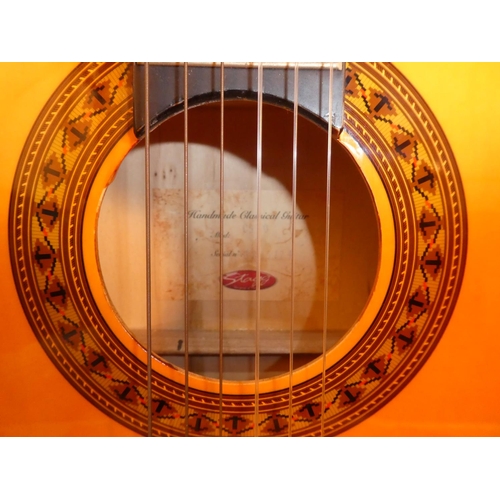 674 - A stunning Stagg handmade wooden classical guitar, model 0530 and bag.