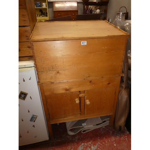 677 - An antique pine storage cupboard with writing slope, measures 22.5