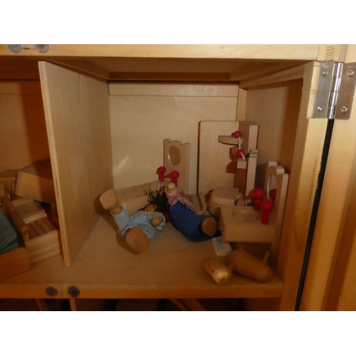 686 - A wooden dolls house containing furniture, dolls and more.