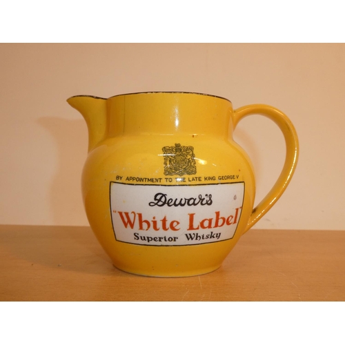 693 - A vintage John Maddock & Sons 'Dewar's White Label' whisky jug (a/f).