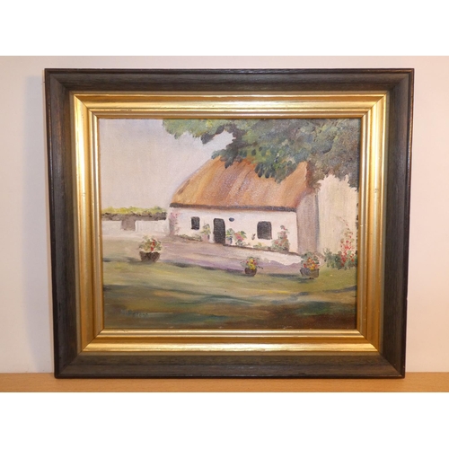 707 - A framed oil painting of an Irish cottage signed.